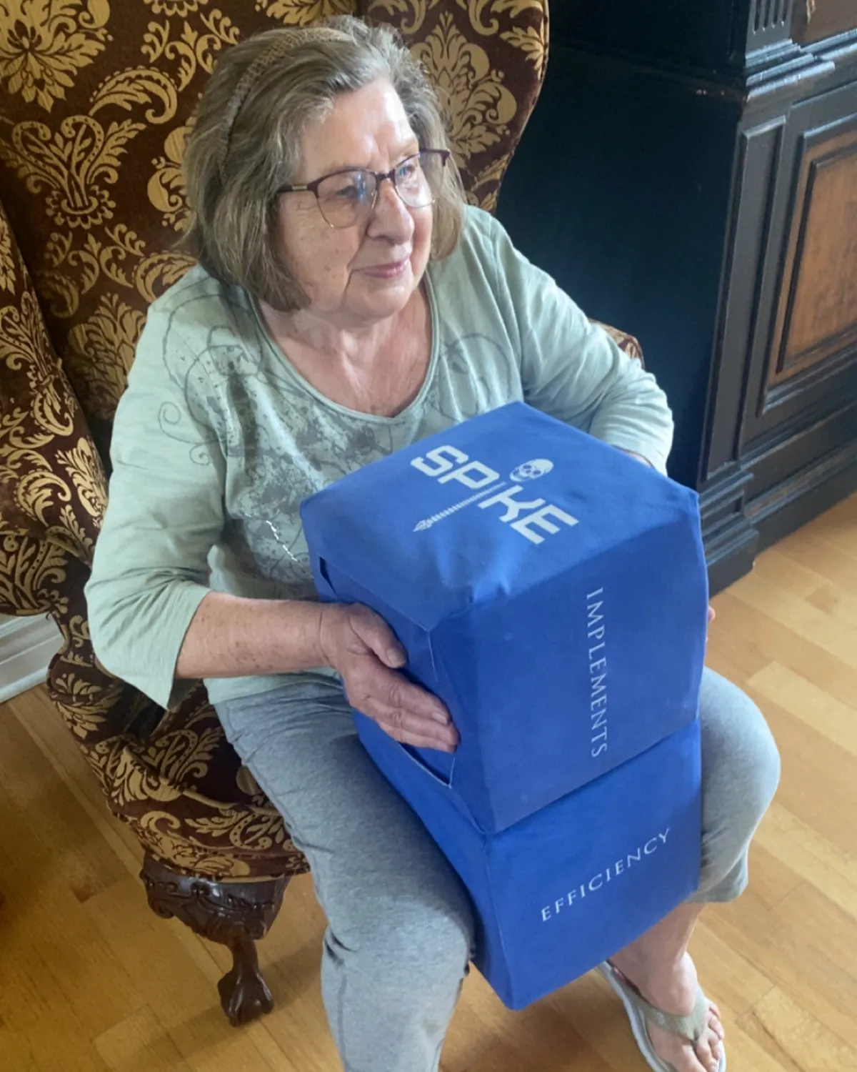 An older woman practising with a SPIKE block at home