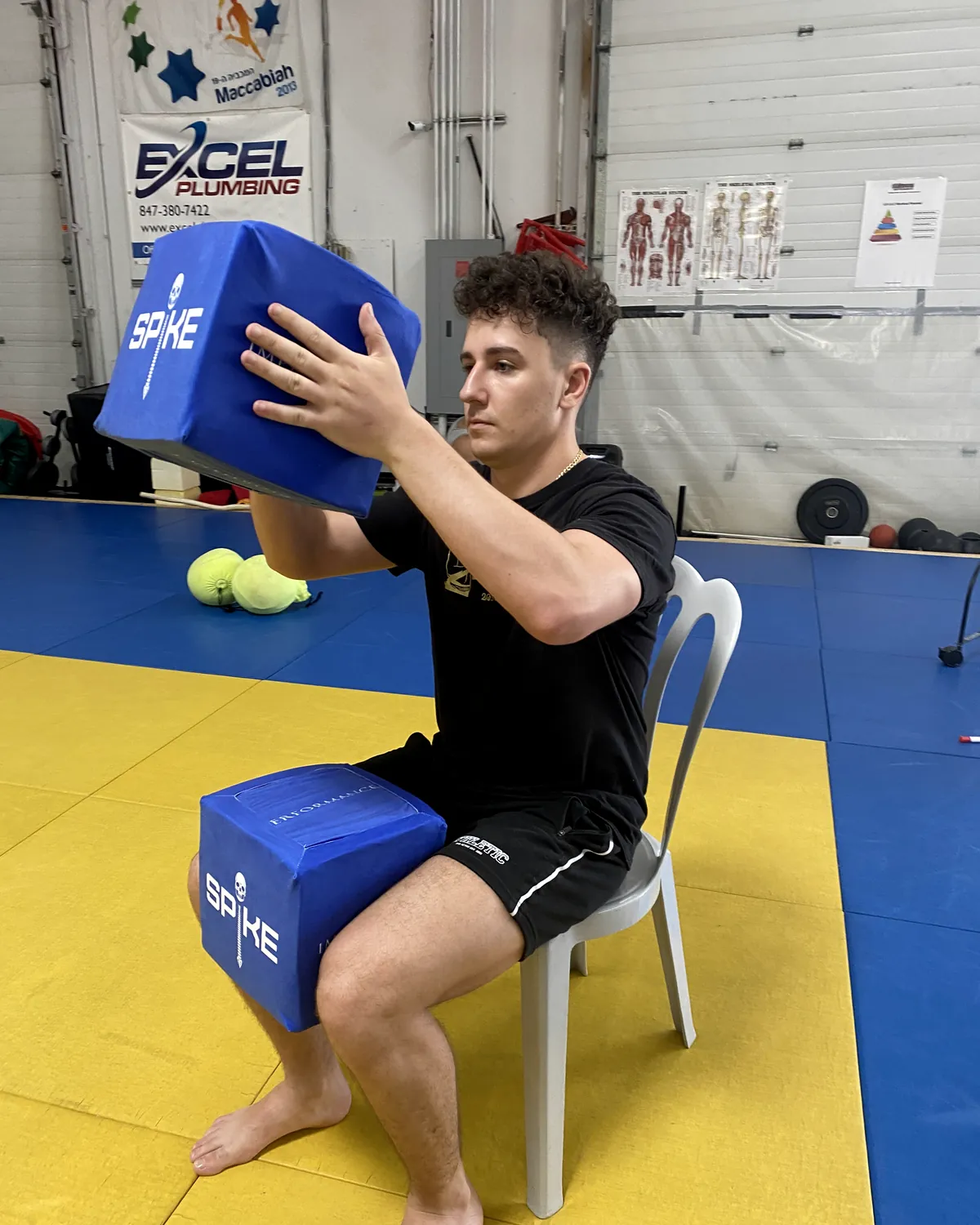 An athlete establishing a SPIKE position on a training floor