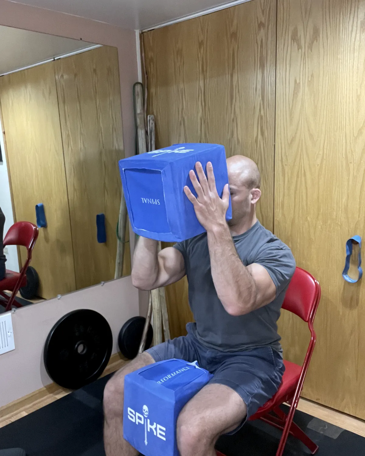 A man creating whole-body tension against a SPIKE block